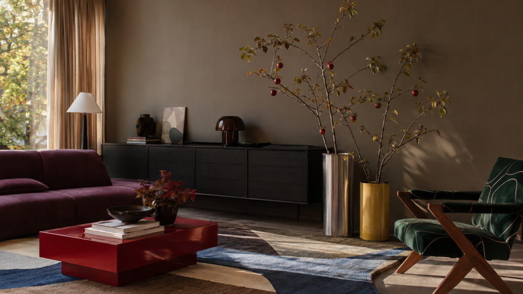 apple-branches-industrial-metal-vessels.webp — Fruit-bearing apple branches displayed in industrial metal vessels beside a modern media cabinet