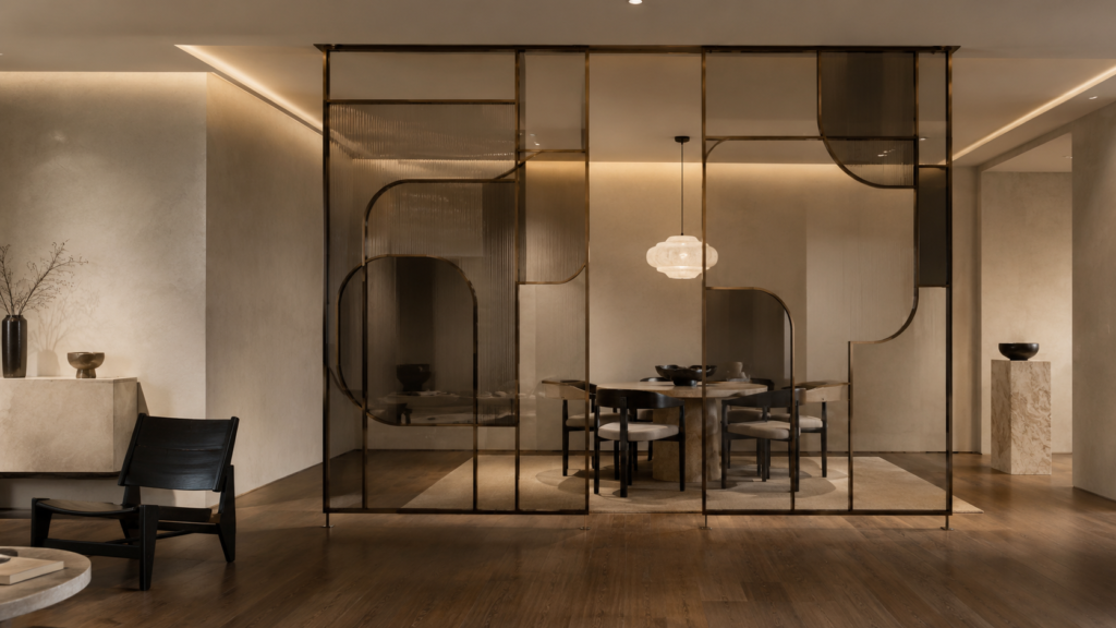 Neo Deco open-plan living room featuring a bronze-framed smoked glass room divider, walnut flooring, sculptural furniture, and minimalist luxury styling.